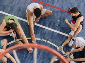 High angle view of basketball players warming up before the match.