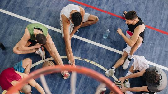 High angle view of basketball players warming up before the match.