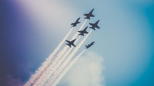 Low Angle View Of Airshow Against Sky
