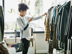 Woman taking photo of clothing with smartphone