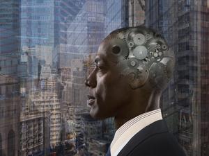 Mixed race businessman with gears in head