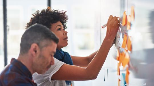 Colleagues brainstorming in a tech start-up office