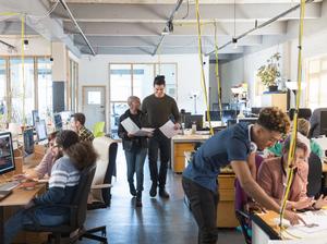 Creative business people working in open plan office