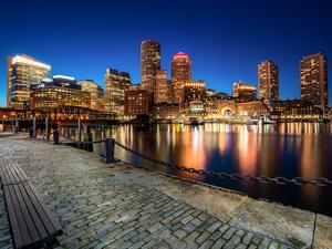 Boston Harbor and Financial District at night in Boston, Massachusetts, USA.