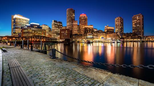 Boston Harbor and Financial District at night in Boston, Massachusetts, USA.