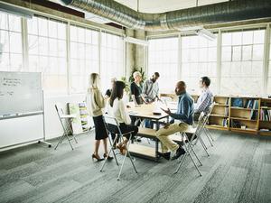 Architects and engineers in project planning meeting at conference table in design studio