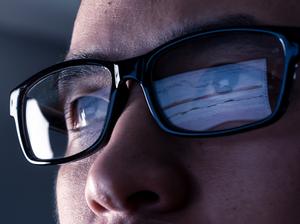 the abstract image of the businessman wear a glasses looking at the stock trading chart on the computer screen. the concept of business, technology, trading, information and internet of things.