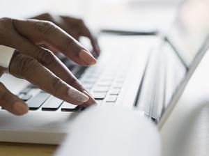 Close up businesswoman typing on laptop