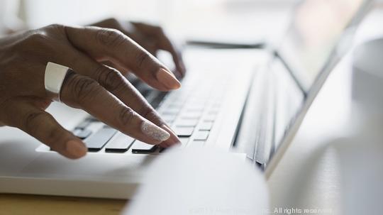 Close up businesswoman typing on laptop