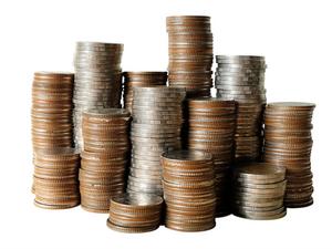 Close-Up Of Coin Stack Against White Background