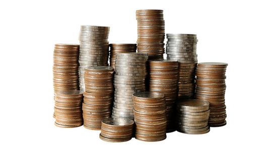 Close-Up Of Coin Stack Against White Background