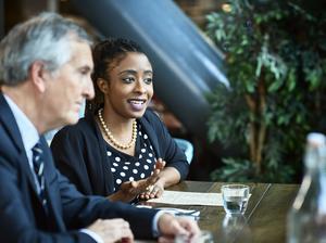 Woman next to male manager in business meeting