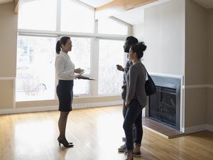 Realtor showing new house to young couple