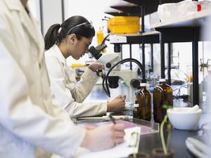 Scientist using microscope in laboratory