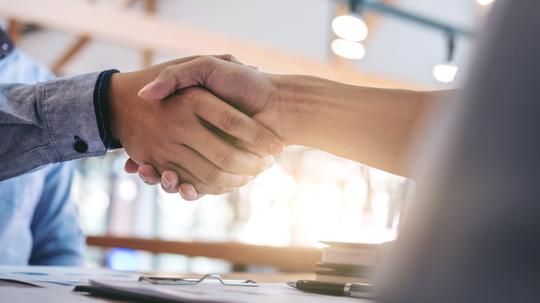 Cropped Image Of Business Colleagues Shaking Hands In Office