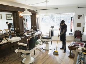 Barber sweeping floor in barber shop