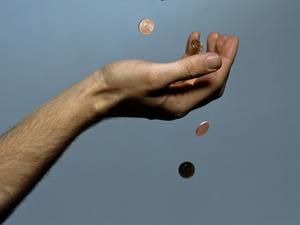 Hands dropping coins