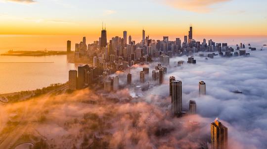 Aerial View Of Buildings And Lake Michigan Against Sky During Sunrise