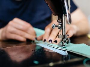 Young Fashion Designer Working On Sewing Machine