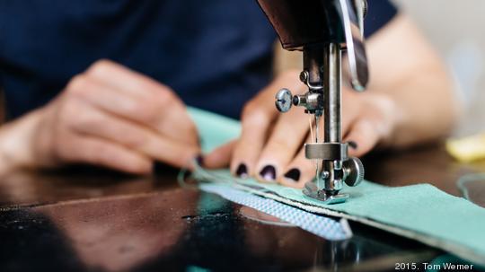 Young Fashion Designer Working On Sewing Machine