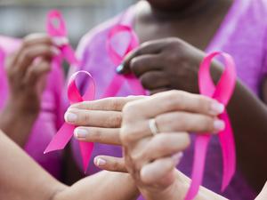 Multi-ethnic women with breast cancer awareness ribbons