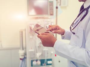 Doctor is working with iPad at the hospital emergency room