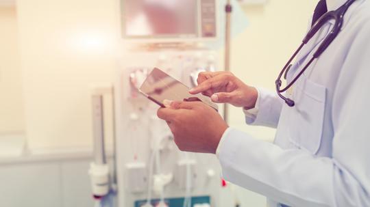 Doctor is working with iPad at the hospital emergency room