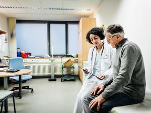 Elderly Man Talking To Doctor About Test Results