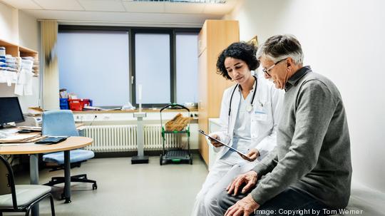 Elderly Man Talking To Doctor About Test Results