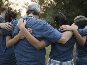 Volunteers hugging in huddle