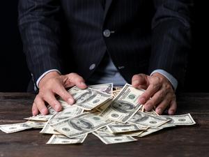 Midsection Of Man With Paper Currencies On Table