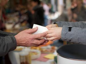 Cropped Image Of Volunteer Giving Food To Person