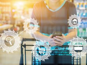 girl leaning on shopping cart, using a mobile phone, trolley in department store bokeh with online shopping and payment icon customer network connection on screen, m-banking for marketing technology