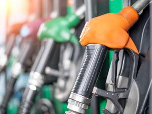 Pumping equipment gas at gas station. Close up of a hand holding fuel nozzle