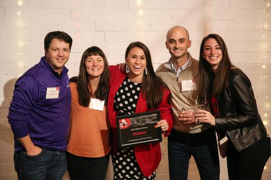 Skipper poses for a photo with their blazer award at Inno on Fire event.