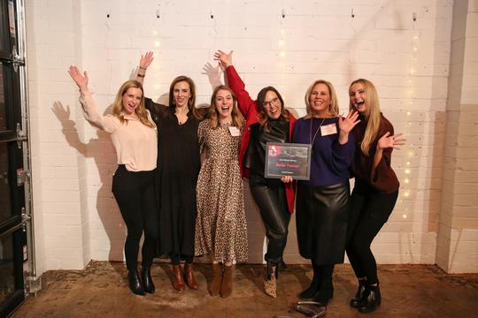 Bella Tunno employees celebrate their blazer award at the Inno on Fire event.