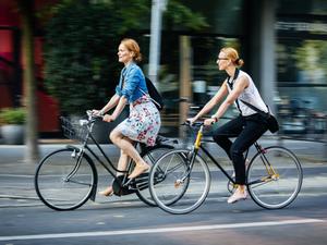 Two women cycling in the city