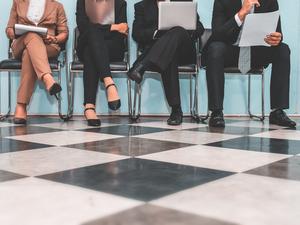 Low Section Of People Waiting For Interview On Chair