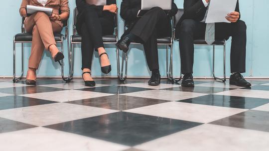 Low Section Of People Waiting For Interview On Chair