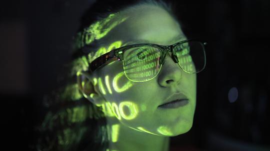 Portrait of girl lighted with green numbers