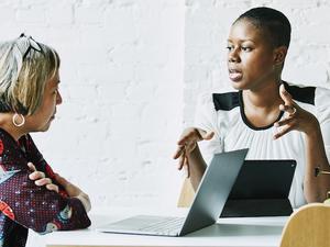 Female financial advisor in discussion with client in office conference room