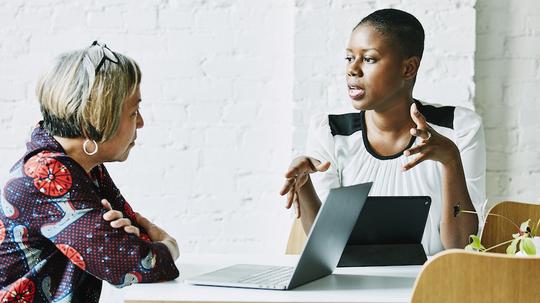 Female financial advisor in discussion with client in office conference room