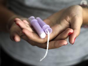 Close-Up Of Woman Hand Holding Tampons