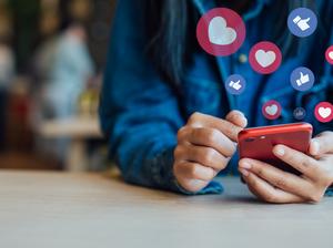 Midsection Of Woman Using Smart Phone On Table In Cafe