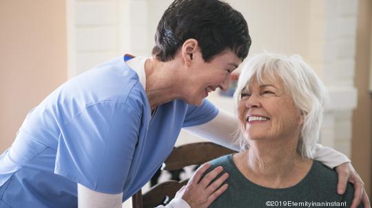 Nurse taking care of elderly lady