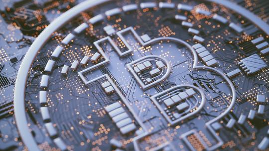 Bitcoin logo on circuit board, illustration