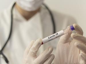 Midsection Of Doctor Holding Test Tube In Laboratory