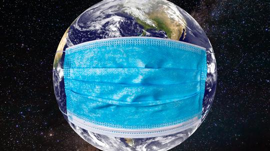 Planet earth with a medical mask. World epidemic concept