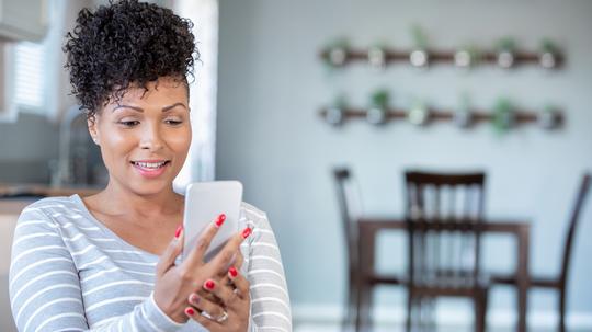 Woman uses smart phone for telemedicine appointment with doctor