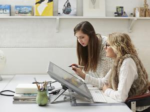 Mature woman showing intern graphics on screen